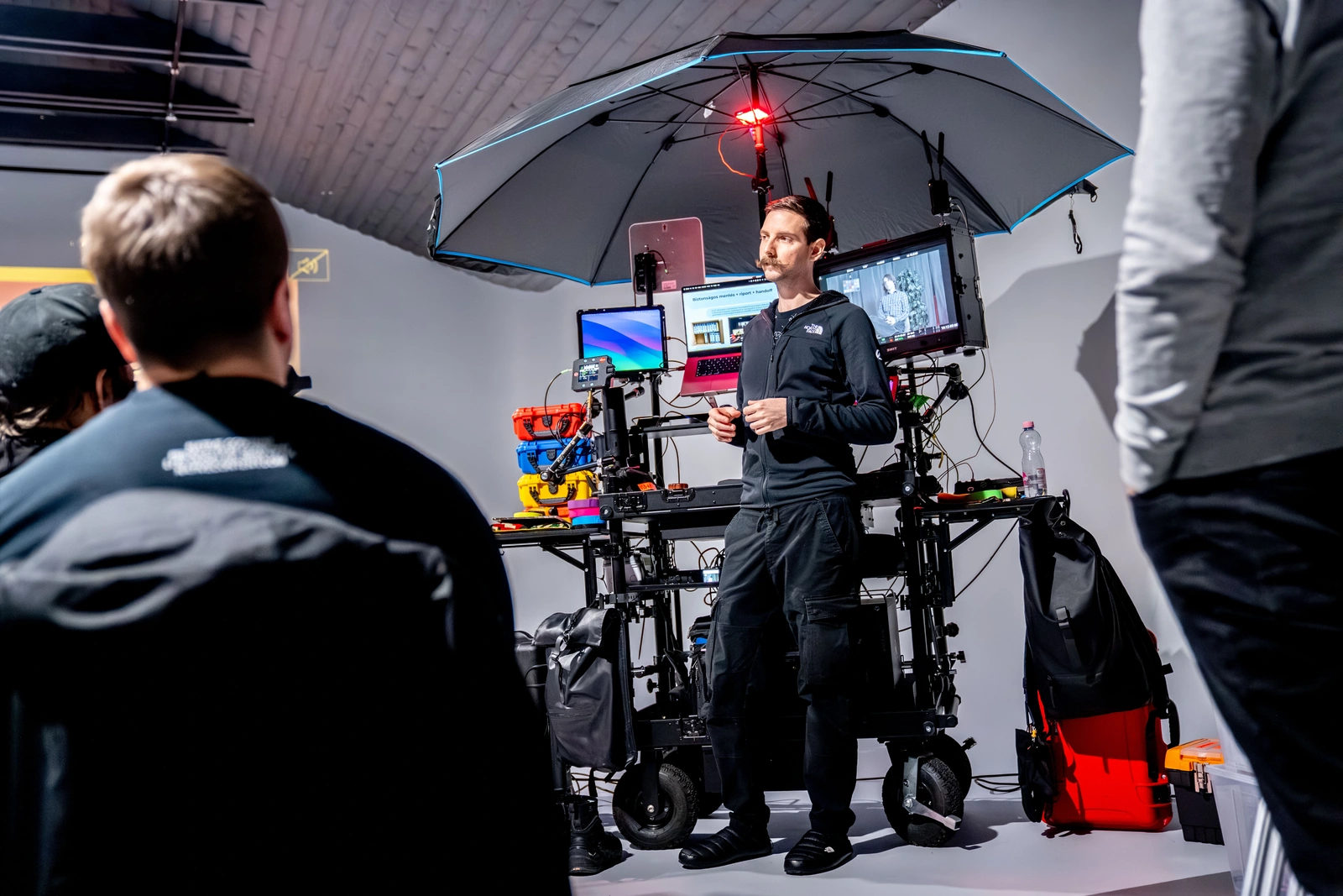 David teaches a group beside a DIT cart and presentation screens